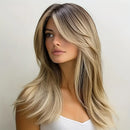 Woman with long, wavy hair transitioning from dark brown to blonde against a plain background, Obroi