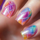 Nails with colorful geometric design on a blurred background, Obroi