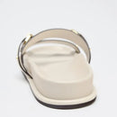 Beige sandal with gold accents on a white background, Obroi