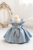 Light blue dress with a large bow on a mannequin against a neutral background, Obroi