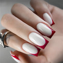 Close-up of a hand with red and white nail design, Obroi