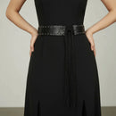 Black dress with a belt on a neutral background, Obroi