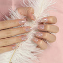 Close-up of a hand with pink nail polish holding a feather against a pink background, Obroi