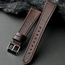 Brown leather watch strap with silver buckle on a dark surface, Obroi