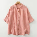 Pink button-up shirt on a wooden hanger against a white background, Obroi