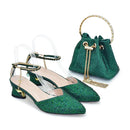 Green glittery shoes with gold accents and a matching green handbag on a white background, Obroi