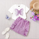 White t-shirt with butterfly design and purple denim skirt on a light gray background with flowers and sandals, Obroi