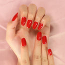 Hand with red nail polish on a pink background, Obroi