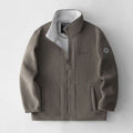 Brown jacket with a brand logo on a light gray background, Obroi