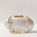 White handbag with gold chain detail on a light gray background, Obroi