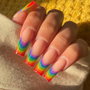 Nails with rainbow design on a textured surface, Obroi