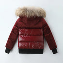 A children's puffer jacket shown from the back, featuring a deep burgundy body with a shiny quilted panel, a thick beige faux-fur trimmed hood, and black ribbed cuffs and hem, Obroi