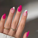 Hand with pink and white floral nail design on a neutral background, Obroi