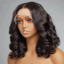 Mannequin head with a black wig on a gray background, Obroi