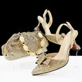 Gold glittery high-heeled shoes and matching handbag on a white background with 'Obroi' branding.