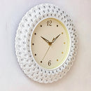 Decorative wall clock with white lace-like design on a light background, Obroi