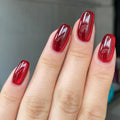 Close-up of a hand with red nail polish on a neutral background, Obroi