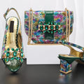 A luxury women's fashion set by Obroi featuring a multicolor reptile-print handbag with green and gold embellishments, paired with matching green and gold high-heeled slingback shoes decorated with large green and gold rhinestones.