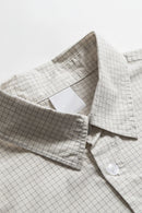 Close-up of a folded checkered fabric with a white background, Obroi