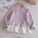 Pink ribbed sweater with white lace hem on a wooden hanger against a neutral background, Obroi