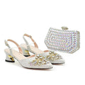 Silver embellished shoes with a matching clutch on a white background, Obroi