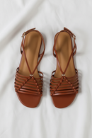 Pair of brown strappy sandals on a white background, Obroi