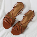 Pair of brown strappy sandals on a white background, Obroi