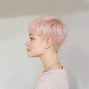 Person with pink hair styled in a short pixie cut against a plain background, Obroi