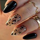 Close-up of a hand with black nail polish and gold and rose gold nail art, Obroi