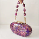 Pink and purple speckled handbag with beaded handle on a white background, Obroi