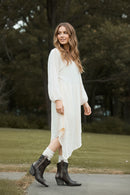 Brown ankle boots worn with white socks on a blurred outdoor background, Obroi