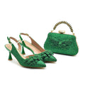 Green glittery high-heeled shoes and matching handbag on a white background, Obroi