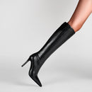 Black knee-high boot with high heel on a light gray background, Obroi