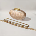 Shell clutch with gold chain on a light background, Obroi