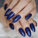 Close-up of hands with dark blue nail polish on a neutral background, Obroi