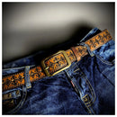 Close-up of blue jeans with a decorative brown belt featuring a gold buckle, Obroi