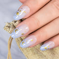 Nail art with gold stars and moons on light blue nail polish, Obroi
