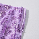 Close-up of purple sequin fabric on a light gray background, Obroi