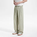 Person wearing light green wide-leg pants on a white background, Obroi