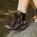 Brown leather boots worn by a person sitting on a rock with a blurred natural background, Obroi