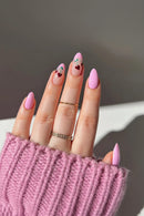 Hand with pink nail polish and a pink sweater sleeve, Obroi