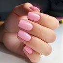 Hand with pink nail polish on a neutral background, Obroi
