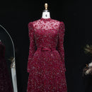 Maroon evening gown with floral embellishments on a mannequin against a black background, Obroi