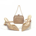 Gold high-heeled shoes and matching handbag on a white background with 'Obroi' branding.