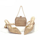 Gold high-heeled shoes and matching handbag on a white background with 'Obroi' branding.
