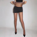 Person wearing sheer black stockings with a plain background, Obroi