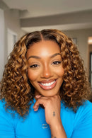 Three-panel collage showing a woman modeling a curly wig. The large left panel shows a smiling woman in a bright blue shirt with the wig styled in tight, glossy brown-to-blonde curls, Obroi