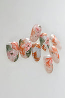 Nail art with floral and fish design on a white background, Obroi