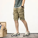 Person wearing beige cargo shorts with a plain background, Obroi
