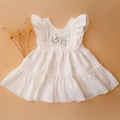 White dress with floral embroidery on a beige background, Obroi